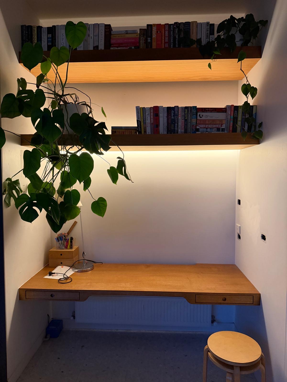 Concealed LED strip lighting beneath timber study shelves